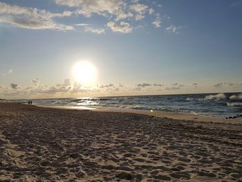 Scenic view of beach against sky during sunset