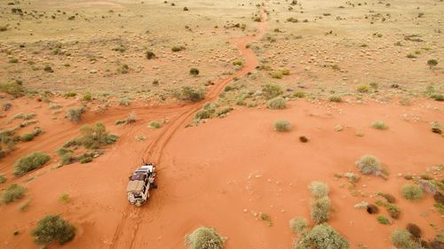 High angle view of vehicle on sand in desert