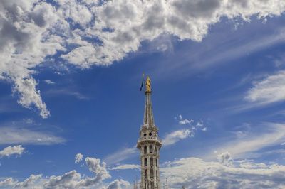 Low angle view of tower of building against cloudy sky