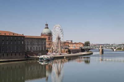 Bridge over river with city in background