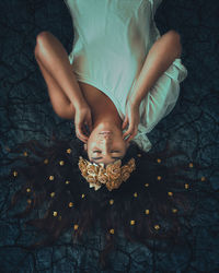 High angle view of young woman wearing flowers