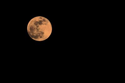 Low angle view of moon against sky at night