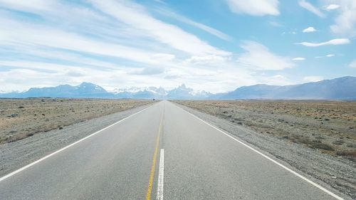 Empty road along countryside landscape