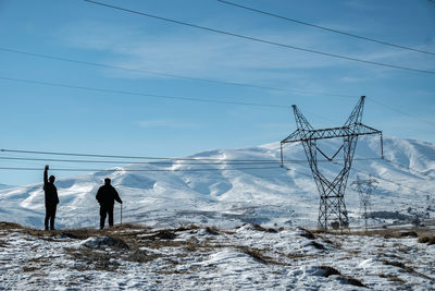 People skiing on snow covered landscape