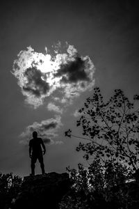 Low angle view of silhouette man standing against sky