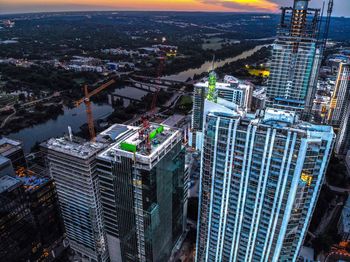 High angle view of buildings in city during sunset