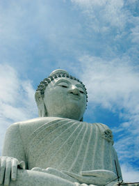 Low angle view of statue against cloudy sky