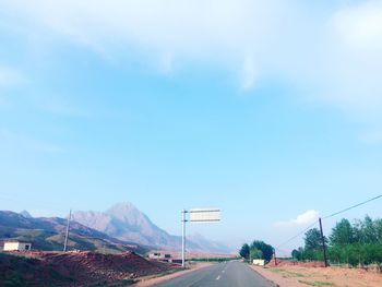 Empty road leading towards mountains