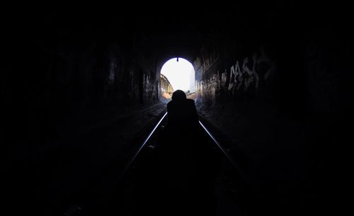 Low angle view of silhouette man in tunnel