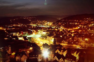 Illuminated cityscape against sky at night