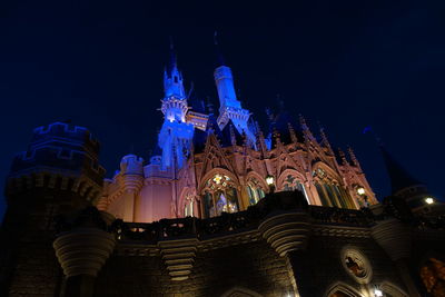 Low angle view of illuminated temple against blue sky