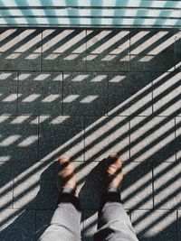 Low section of man standing on street