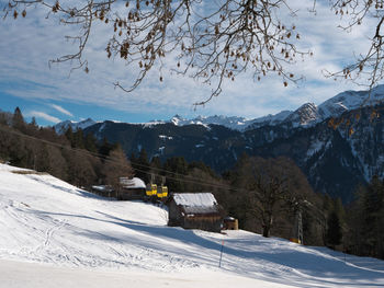 Scenic view of snow covered mountains against sky