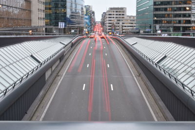 Vehicles on road against buildings in city