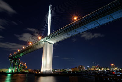 Low angle view of illuminated bridge against sky at night