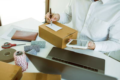 Midsection of businessman working in office