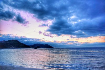 Scenic view of sea against dramatic sky