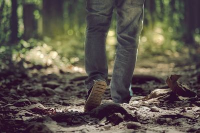 Low section of man standing on ground