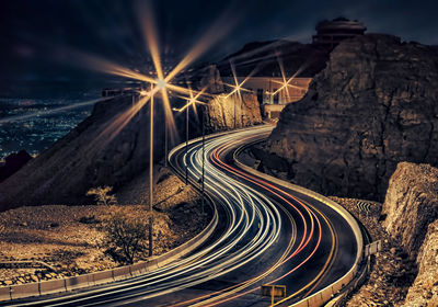 High angle view of light trails on highway at night