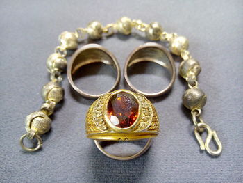 Close-up of rings and bracelet on table