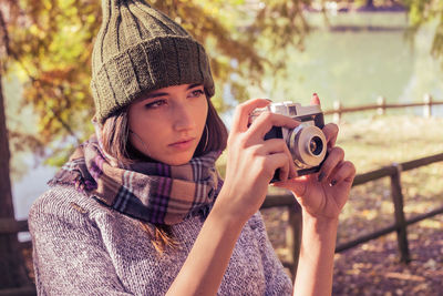 Portrait of teenage girl photographing