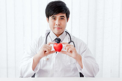 Portrait of doctor with stethoscope sitting in hospital