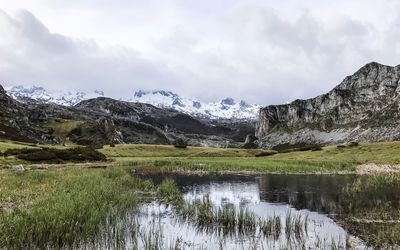 Scenic view of lake and mountains against sky