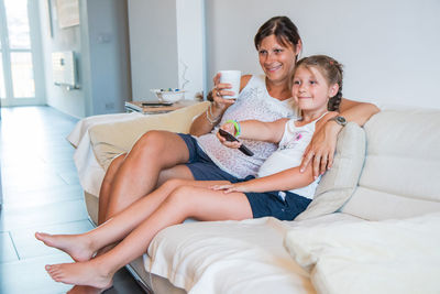 Young woman sitting on sofa