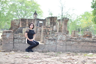 Portrait of young woman sitting outdoors