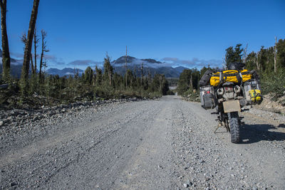 Touring motorbike parked on gravel road on the carretera austral