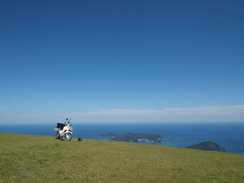 Motorcycle on field against sky