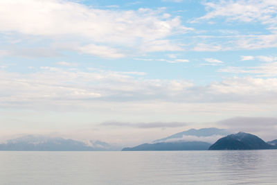 View of calm sea against mountain range