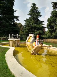 Man in swimming pool against sky