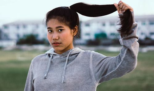 Portrait of teenage girl standing outdoors
