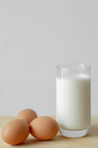 Close-up of eggs and milk on table