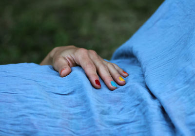 Close-up of woman with multi colored nail paint