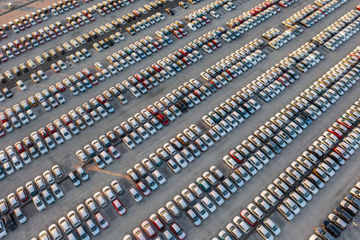 Aerial view of brand new cars at the logistics center, near the factory. car parking lot.