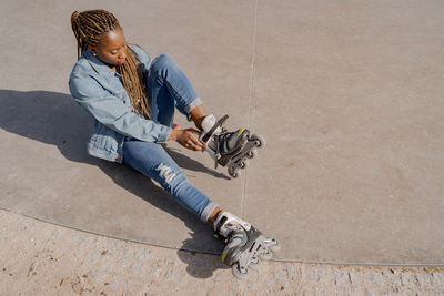 High angle view of girl sitting outdoors