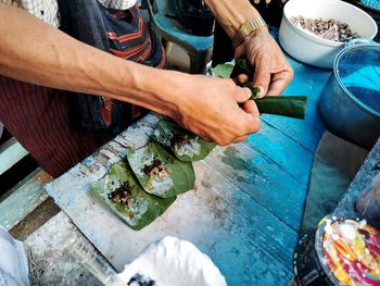 High angle view of man preparing food on table