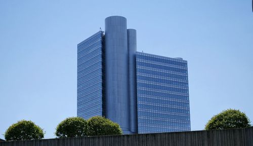 Low angle view of skyscrapers against clear blue sky