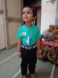 Portrait of smiling boy standing in corridor
