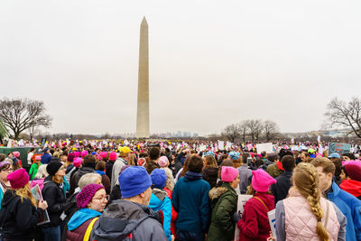 Crowd of people against sky