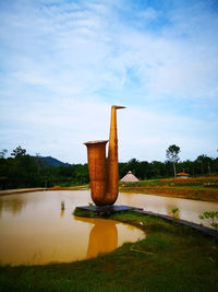 Built structure on lake against sky