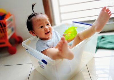 Cute boy holding toy at home