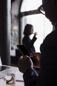 Businessman using mobile phone in conference center