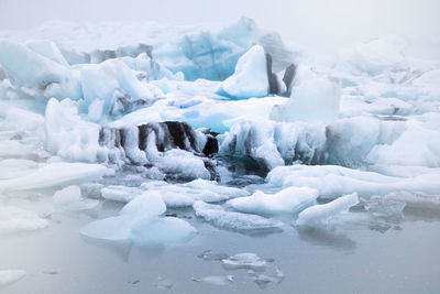 Scenic view of frozen lake against sky