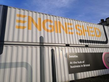 Low angle view of information sign against sky