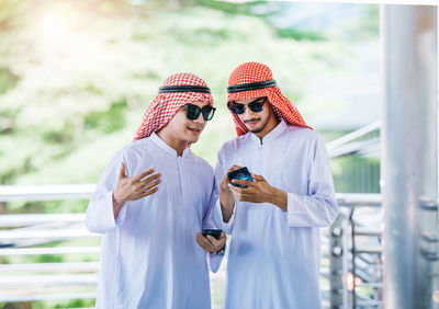 Business colleagues wearing traditional clothing while standing outdoors