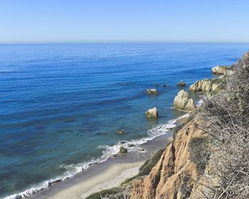 Scenic view of sea against clear blue sky