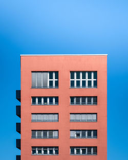 Low angle view of building against blue sky